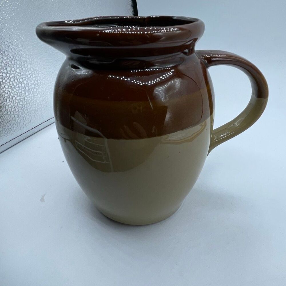 Vintage brown & tan glazed stoneware crock pitcher.
